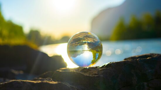A Glass ball surrounded by nature. In the back you can see the river called Inn.