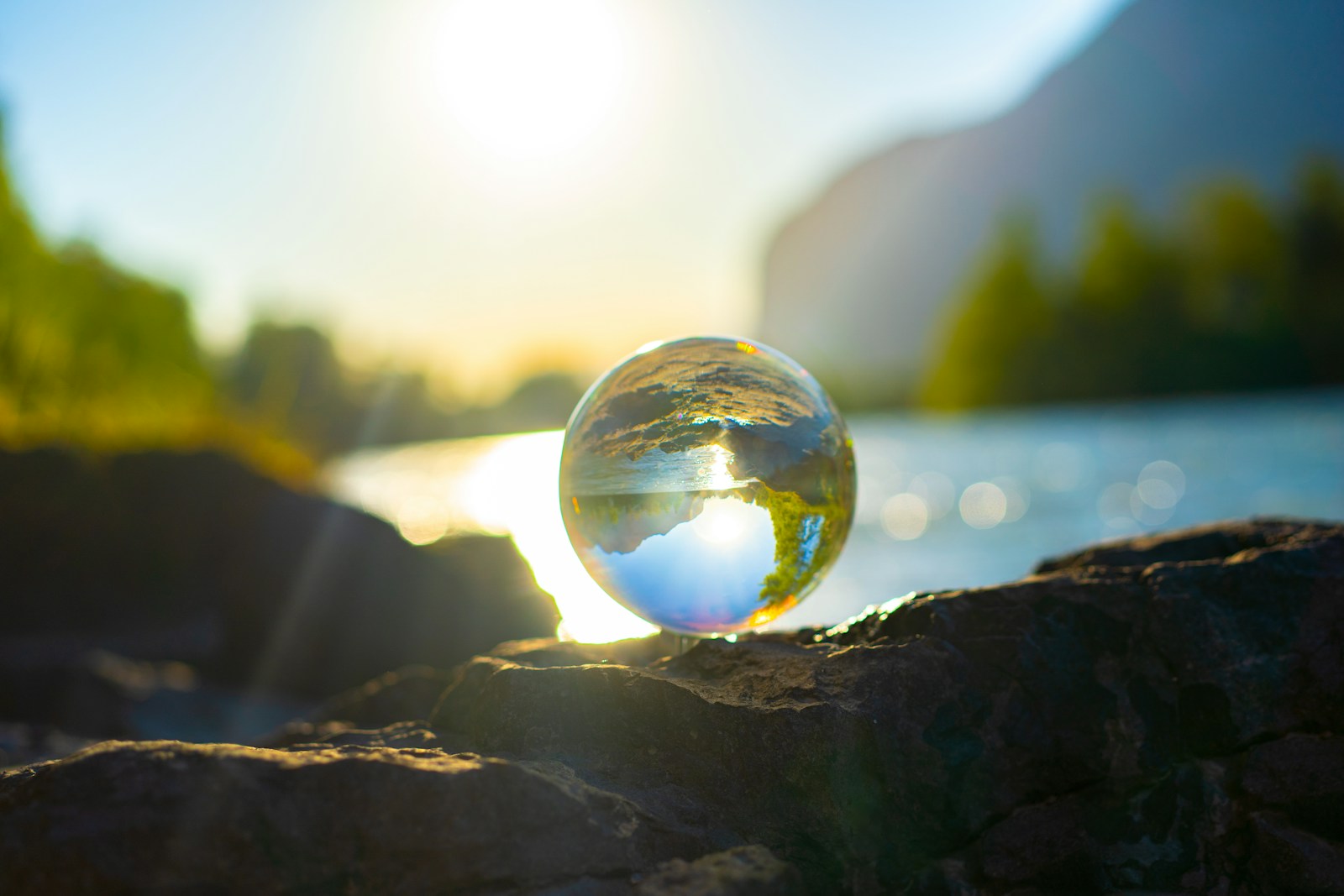A Glass ball surrounded by nature. In the back you can see the river called Inn.